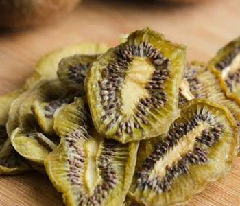 Solar dried kiwi fruits with improved shelf life, natural color retention, and preserved nutritional value.