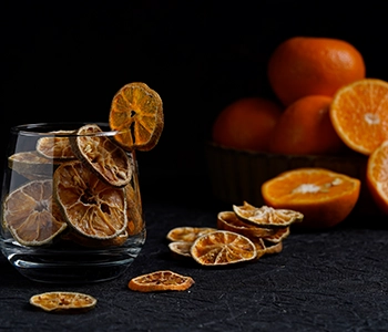Solar dried oranges processed for extended shelf life while preserving flavor, aroma, and quality.