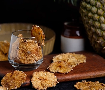 Solar dried pineapple slices with retained natural taste, texture, and extended storage life.