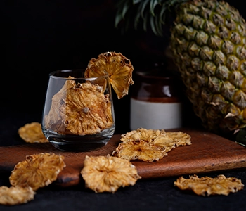 Pineapple fruit slices dried in solar dryer for preservation and improved market value in Gujarat